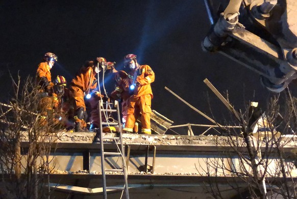 epa08484305 Rescuers work on a damaged building in the aftermath of an oil tanker truck