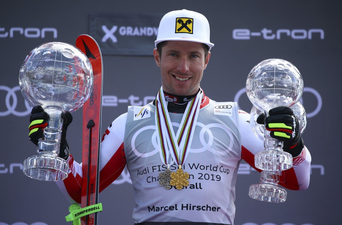 FILE - Austria's Marcel Hirscher poses on the podium with the trophies for men's alpine ski World Cup overall leader, giant slalom and slalom, in Soldeu, Andorra, on March 17, 2019. Eight-ti ...