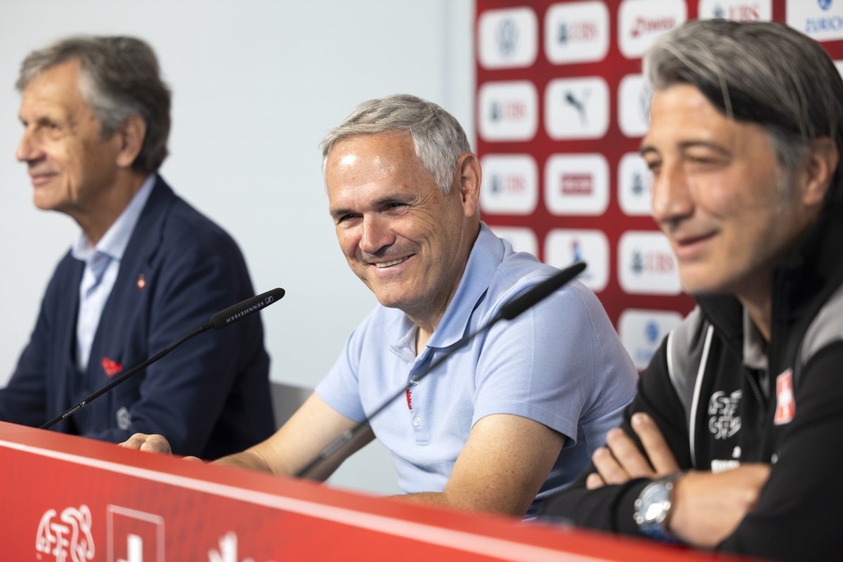 Switzerland's head coach Murat Yakin, team director Pierluigi Tami and Dominique Blanc, president of the Swiss football federation, front to back, attend a press conference at the "Stadion a ...