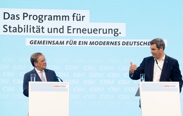 epa09290420 Christian Democratic Union (CDU) party chairman Armin Laschet (L) and Leader of the Christian Social Union (CSU) and Bavaria&#039;s State Premier Markus Soeder attend a press conference af ...