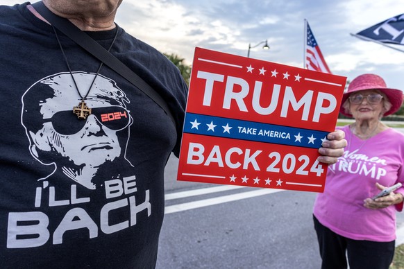epa11380800 Former US President Donald Trump supporters stand in front of Trump���s Mar-a-Lago property after the guilty verdict in West Palm Beach, Florida, USA, 30 May 2024. Trump was found guilty o ...