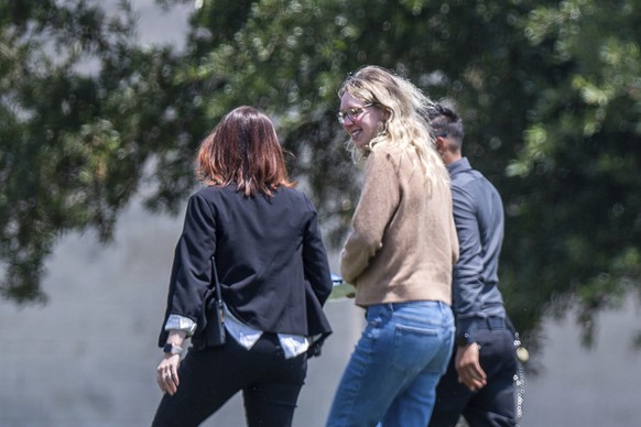 Elizabeth Holmes, founder of the failed blood testing start-up Theranos, center, is escorted by prison officials into the federal prison camp in Bryan, Tuesday, May 30, 2023. (Meredith Seaver/College  ...
