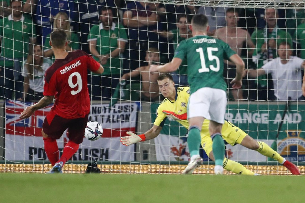 Northern Ireland's goalkeeper Bailey Peacock-Farrell, back, saves a penalty shot by Switzerland's Haris Seferovic, left, during the World Cup 2022 group C qualifying soccer match between Nor ...