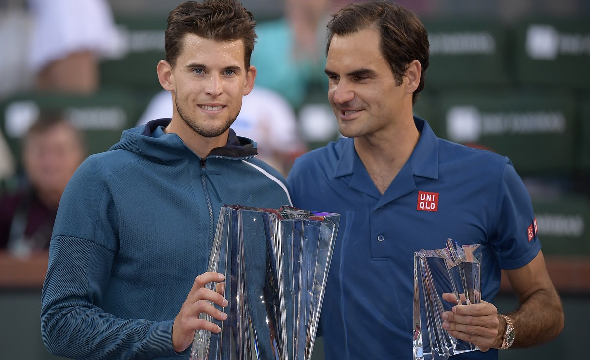 Dominic Thiem, of Austria, left, and Roger Federer, of Switzerland, pose with trophies after Thiem defeated Federer in the men's final at the BNP Paribas Open tennis tournament Sunday, March 17,  ...
