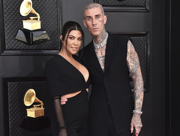 FILE - Kourtney Kardashian, left, and Travis Barker appear at the 64th Annual Grammy Awards in Las Vegas on April 3, 2022. TMZ was first to report Tuesday that the two married at a Las Vegas chapel ju ...