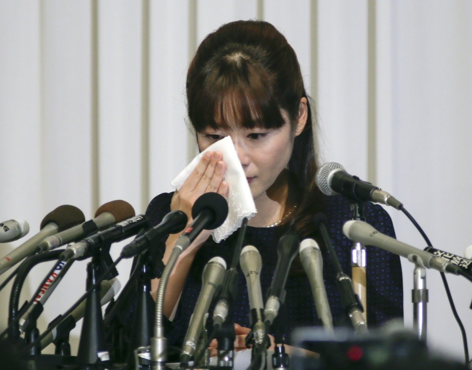 epa04160009 Japanese scientist and researcher Haruko Obokata wipes her tears during a news conference held in Osaka, western Japan, 09 April, when she appeared to the public for the first time after s ...