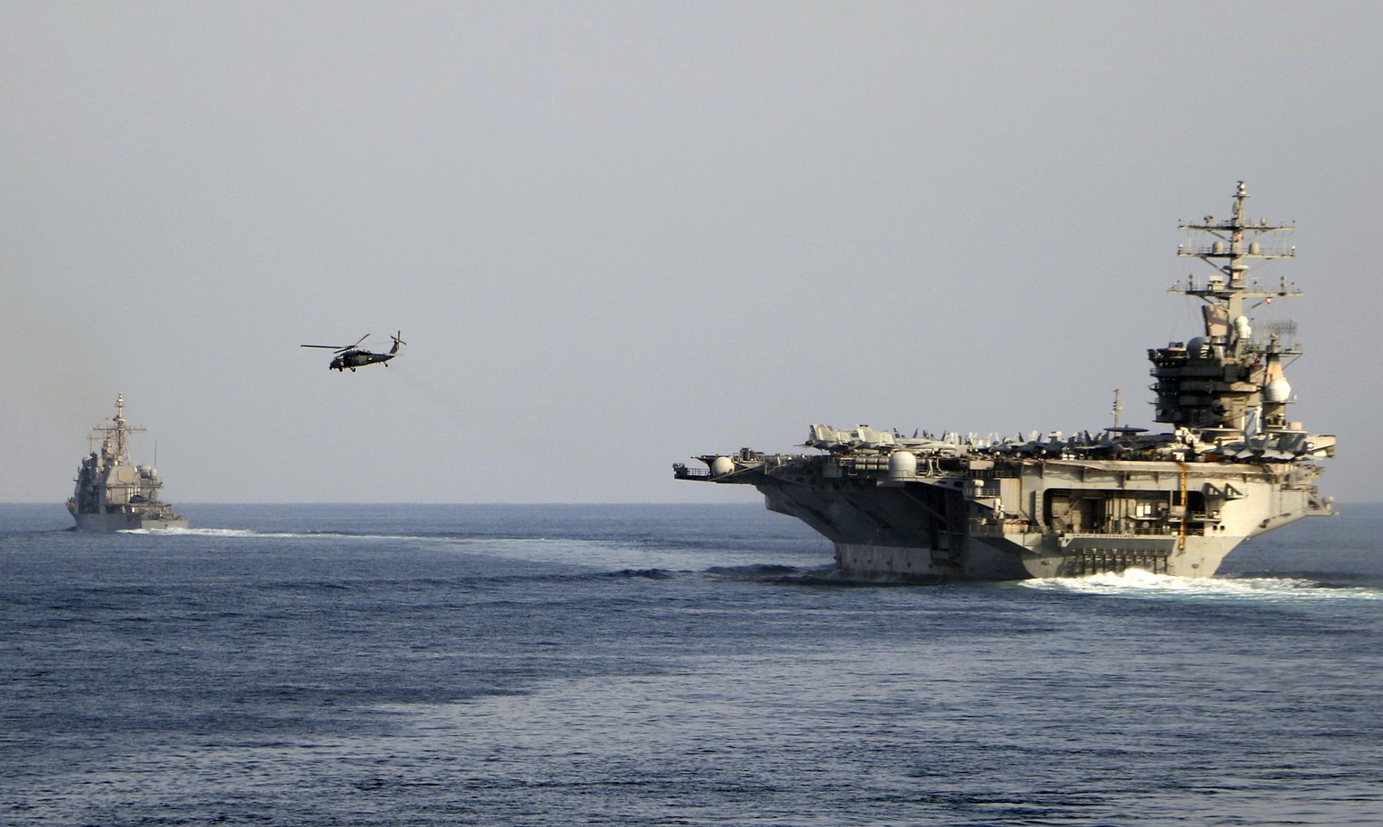 The aircraft carrier USS Dwight D. Eisenhower and other warships crosses the Strait of Hormuz into the Persian Gulf on Sunday, Nov. 26, 2023, as part of a wider American deployment in the Middle East  ...
