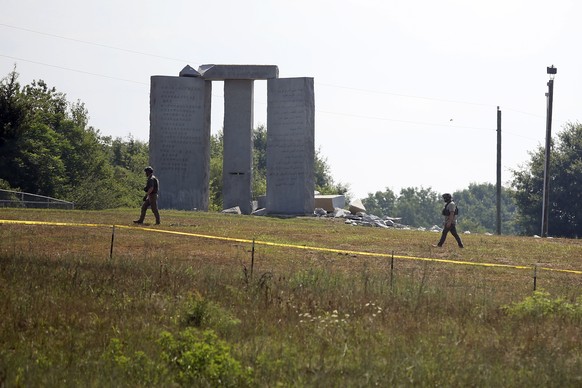 Law enforcement officials walk around the damaged Georgia Guidestones monument near Elberton, Ga., on Wednesday, July 6, 2022. The Georgia Bureau of Investigation said the monument, which some Christi ...