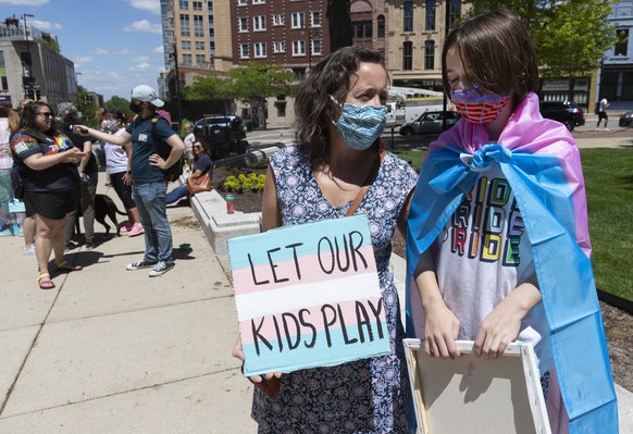 Maddy Niebauer and her 10-year-old transgender son, Julian, from Middleton, Wis., take part in a rally for transgender rights that drew about 75 people Wednesday, May 26, 2021, at the Capitol in Madis ...