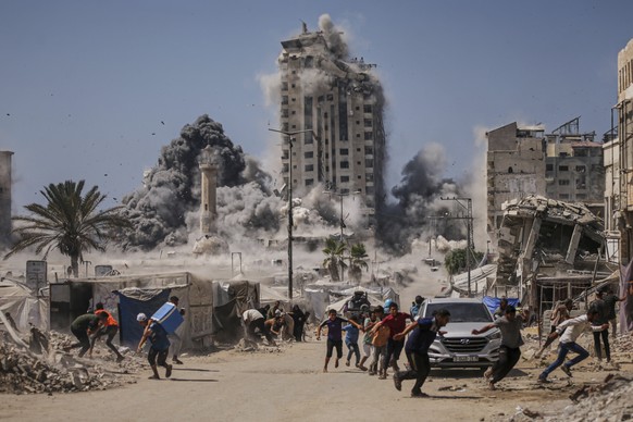 FILE - Palestinians run for cover during an Israeli airstrike on a high-rise building in Gaza City, Friday, Sept. 5, 2025, after the Israeli army issued a warning. (AP Photo/Yousef Al Zanoun, File)
Mi ...