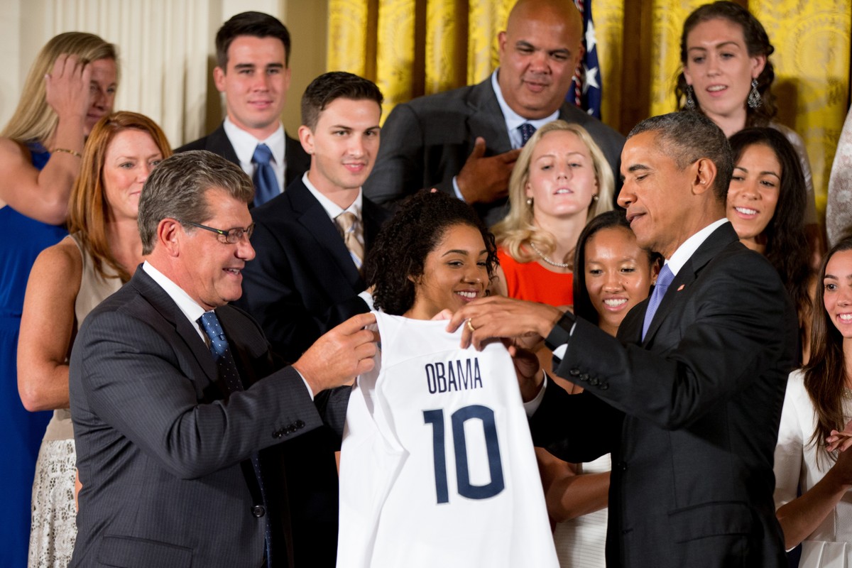 UConn Huskies Women's head basketball coach Geno Auriemma, left, presents President Barack Obama with a UConn Huskies jersey in the East Room of the White House in Washington, Tuesday, Sept. 15,  ...