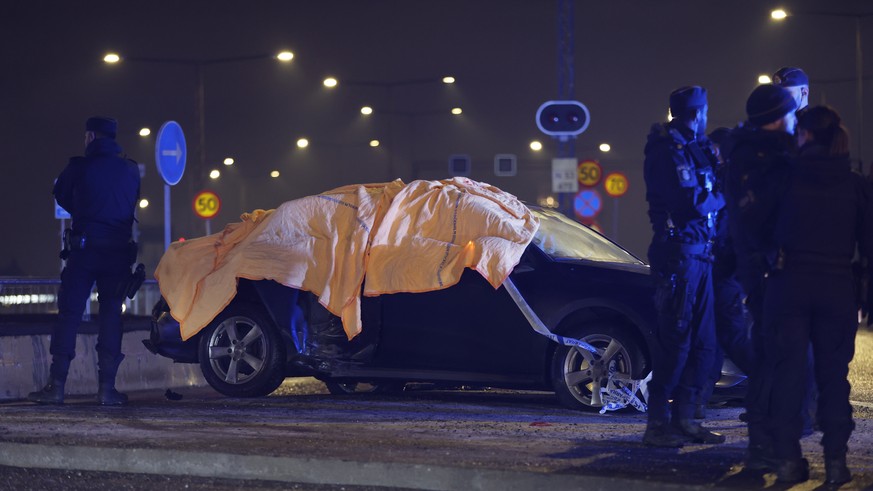 Police stand by a crashed car in Gullmarsplan, Stockholm after police chased the car on Friday, January 20, 2023.  Police found weapons in the car and two people were arrested after the crash.  (Ch...