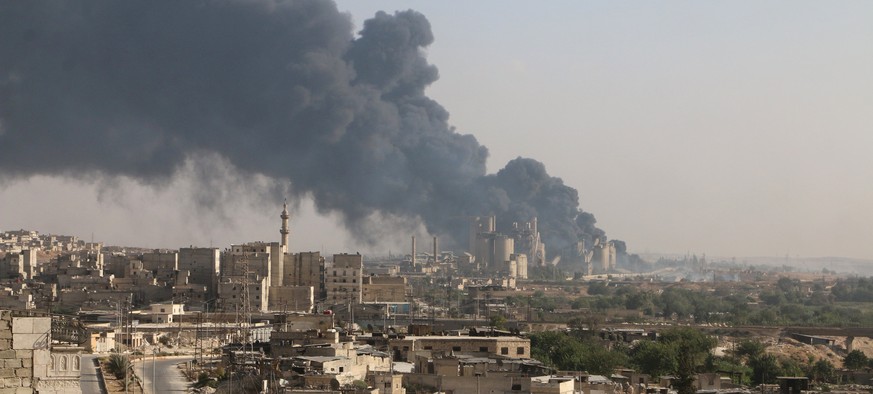 A general view shows rising smoke from a Syrian regime controlled cement factory, in Aleppo, Syria August 9, 2016. REUTERS/Abdalrhman Ismail