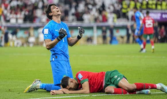 Morocco&#039;s goalkeeper Yassine Bounou, left, celebrates with his teammate Morocco&#039;s Achraf Hakimi their team victory over Portugal during the World Cup quarterfinal soccer match between Morocc ...