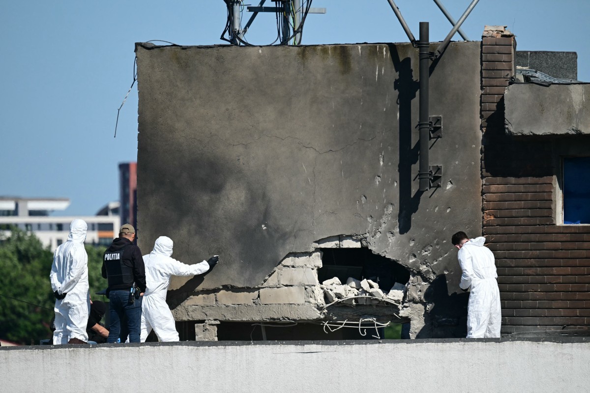 Police and forensic investigators examine the location of impact after a Russian drone struck an apartment building in Galati, western Romania. A Russian drone wounded two people as it struck an apart ...