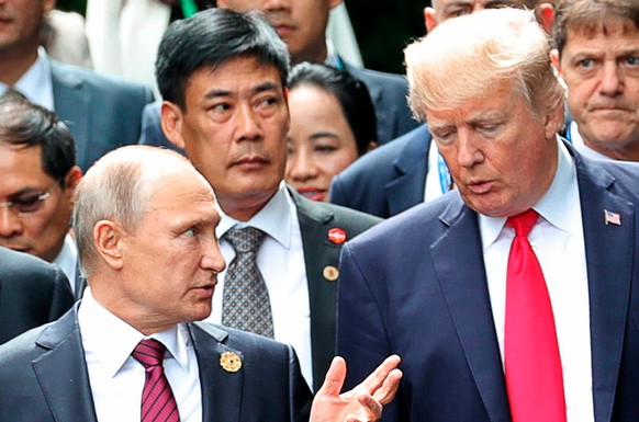 FILE - In this Nov. 11, 2017, file photo, President Donald Trump, right, and Russia President Vladimir Putin talk during the family photo session at the APEC Summit in Danang. The Trump administration ...