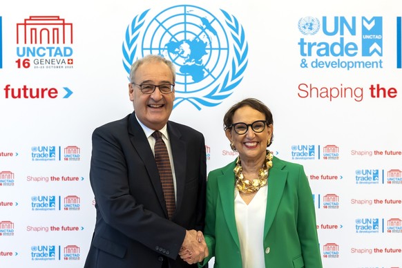 Swiss Federal Councilor Guy Parmelin, left, and Rebeca Grynspan, Secretary-General of the United Nations Conference on Trade and Development (UNCTAD) shake hands, prior to the UNCTAD 16 intergovernmen ...
