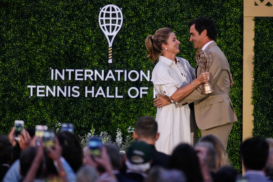 KEYPIX - Roger Federer is embraced by his wife Mirka during his induction ceremony at the International Tennis Hall of Fame, Saturday, Aug. 29, 2026, in Newport, Rhode Island. (AP Photo/Charles Krupa)