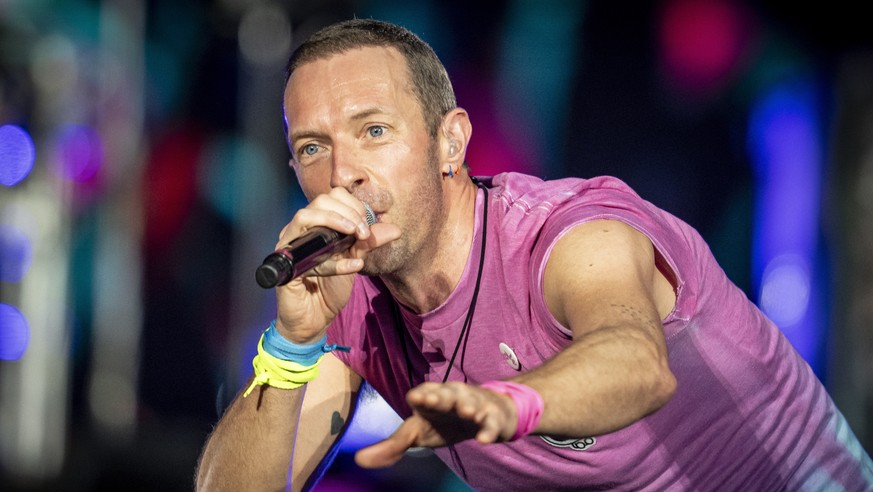 epa10728899 British singer Chris Martin of British band Coldplay performs at Parken Stadium in Copenhagen, Denmark, 05 July 2023. The concert is part of the Music of the Spheres World Tour. EPA/Mads C ...