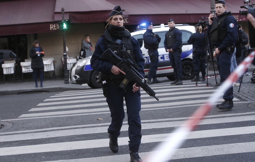 Police officers take position outside the Louvre museum in Paris,Friday, Feb. 3, 2017. Paris police say a soldier has opened fire outside the Louvre Museum after he was attacked by someone, and the ar ...