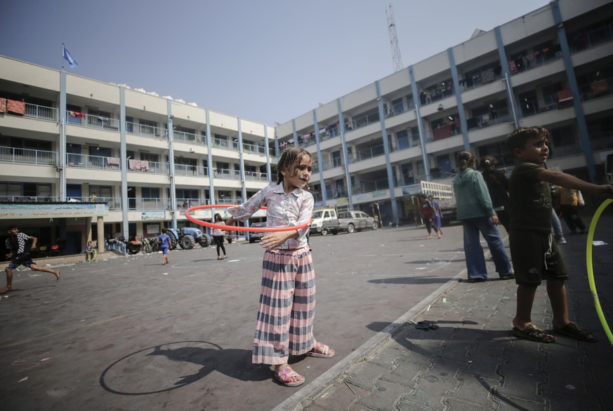 epa10907421 A Palestinian child plays at an UNRWA school where people gathered after they fled following Israeli strikes in the northern and eastern Gaza Strip, in Gaza City, 08 October 2023. Accordin ...