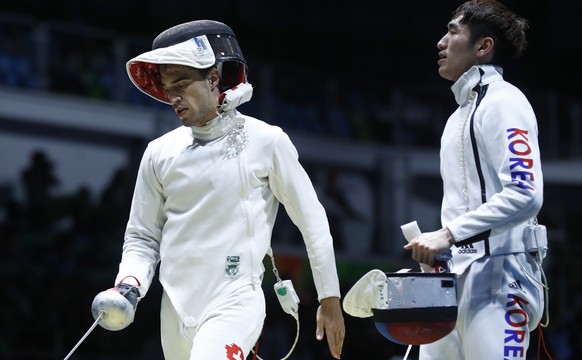 Switzerland&#039;s Max Heinzer, left, reacts after losing against Korea&#039;s Sangyoung Park in the men&#039;s epee individual quarter final in the Carioca Arena 3 in Rio de Janeiro, Brazil, at the R ...