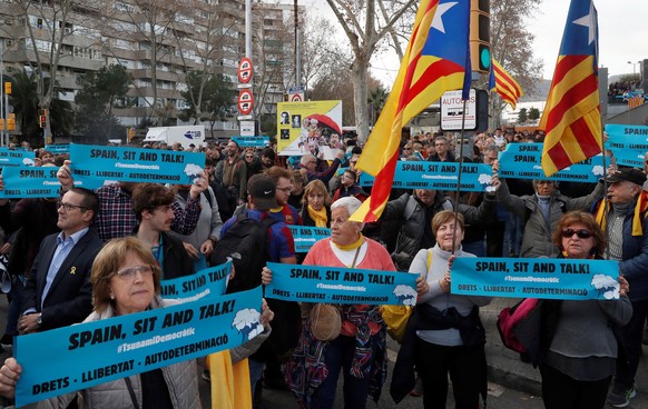 epa08079492 People attend a protest called for by the pro-Catalan independence initiative 'Tsunami Democratic' near the Camp Nou stadium in Barcelona, Spain, 18 December 2019, ahead of a Spanish LaLiga soccer match between FC Barcelona and Real Madrid at the Camp Nou stadium. Barcelona will face Real Madrid in their Spanish LaLiga soccer match, initially scheduled for 26 October 2019.  EPA/TONI ALBIR