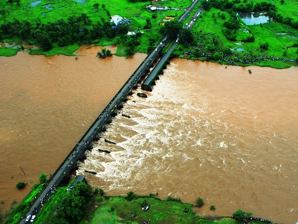 This photo released by the public relations office of Indian Defence shows an old bridge that collapsed in a flooded river in western Maharashtra state, India, Wednesday, Aug. 3, 2016. Two buses plung ...