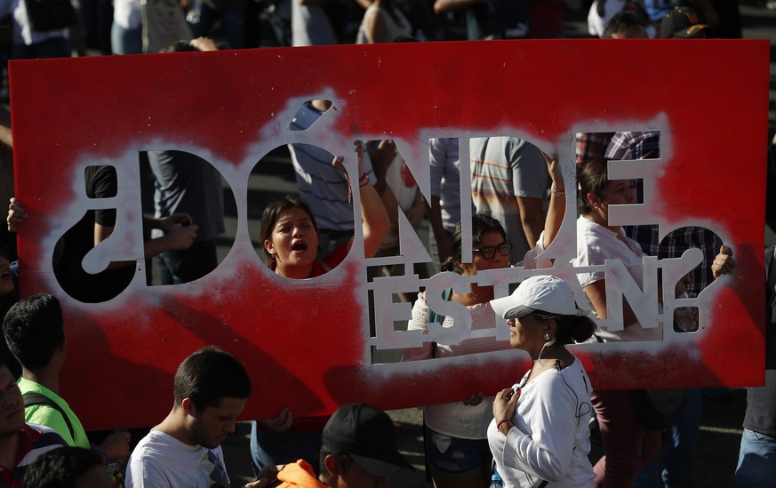 Students hold a sign that reads in Spanish &quot;Where are they?&quot; during a protest against the murder of three film students who have become emblematic of Mexico&#039;s missing, in Guadalajara, M ...