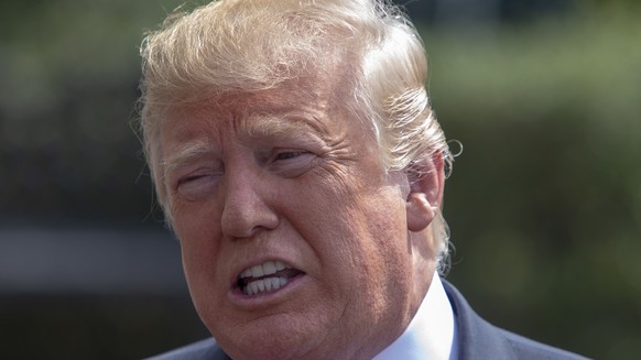 epa06954586 US President Donald J. Trump talks to the media before boarding Marine One on the South Lawn of the White House in Washington, DC, USA, 17 August 2018. Trump departs the White House for We ...