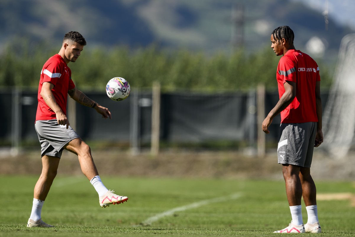 Switzerland's midfielder Granit Xhaka, left, plays the ball next to Switzerland's defender Manuel Akanji during a training session of the Swiss national soccer team, in Riddes, Switzerland,  ...
