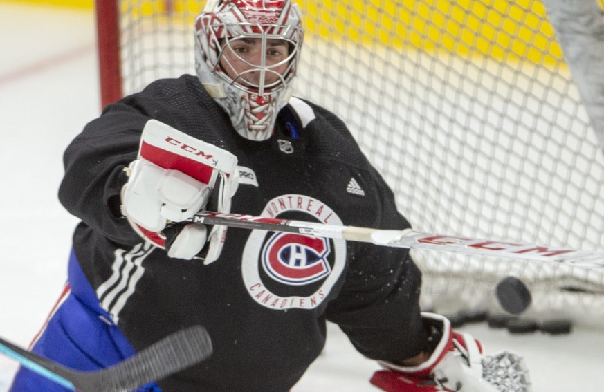 Montreal Canadiens goaltender Carey Price bats away a loose puck during practice in Brossard, Quebec, Tuesday, July 14, 2020. (Ryan Remiorz/The Canadian Press via AP)