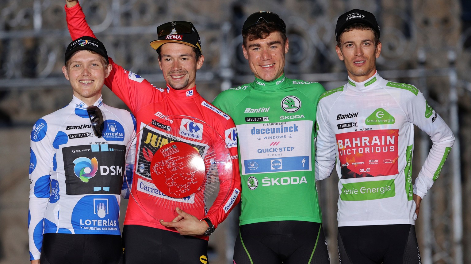 epa09450289 (L-R) Australian rider Michael Storer of DSM Team, with the king of the mountain dotted jersey, Slovenian rider and winner of La Vuelta Primoz Roglic of Jumbo Visma team, Dutch rider Fabio ...