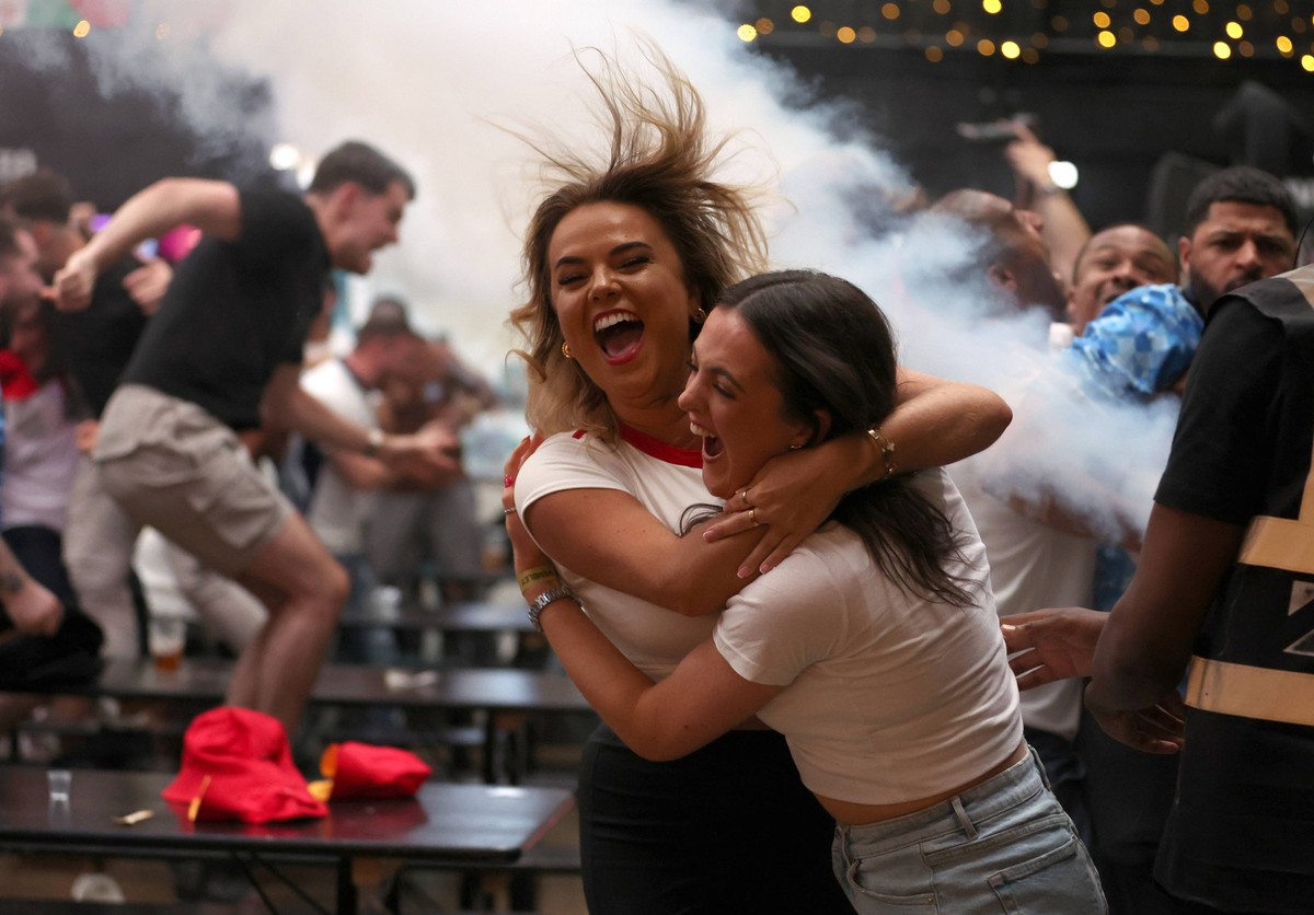 Fans watching England v Slovakia - EUFA Euro 2024 England fans at BOXPark Wembley in London celebrate after England s Jude Bellingham scores a late equaliser during a screening of the UEFA EURO, EM, E ...