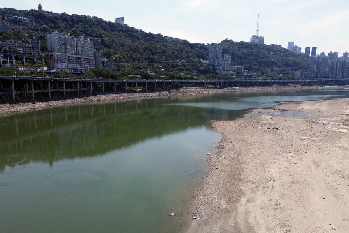 In this aerial photo, the lower than normal bank of the Jialing River is seen in southwestern China's Chongqing Municipality, Friday, Aug. 19, 2022. Ships crept down the middle of the Yangtze on  ...
