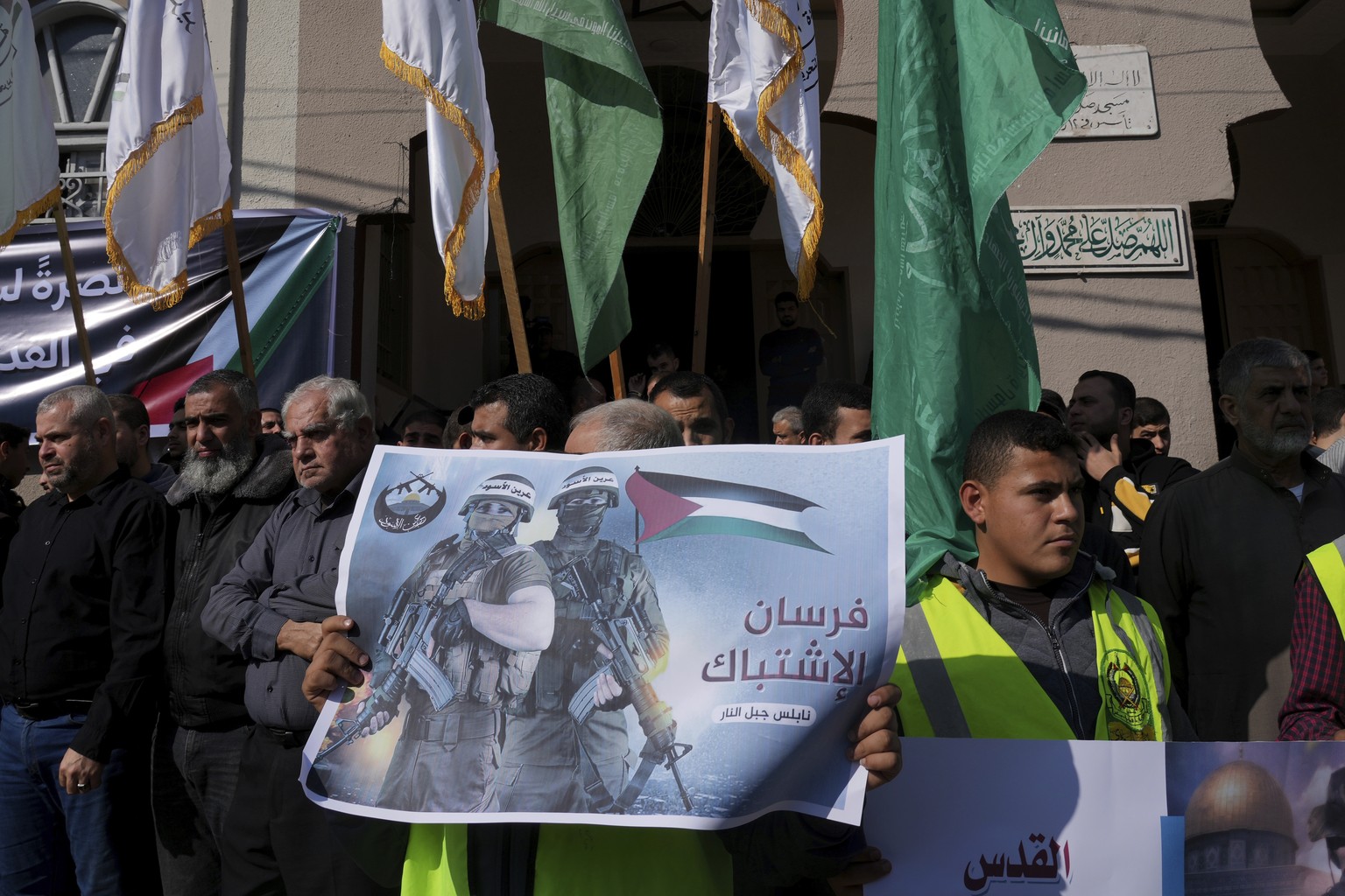 Hamas supporters wave green Islamic flags during a rally in solidarity with Palestinian residents of the West Bank and Jerusalem, after Friday prayer in front of Salah elDein Mosque at the main road o ...