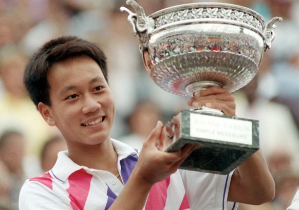American tennis player Michael Chang, 17, holds the winner's trophy after he won the French open tennis championships in this June 11, 1989 photo, in Paris. Michael Chang will retire after the U.S. Op ...
