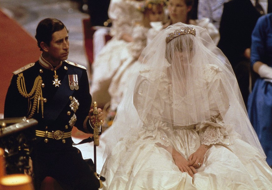 FILE - In this July 29, 1981 file photo, Britain's Prince Charles and Lady Diana Spencer are shown on their wedding day at St. Paul's Cathedral in London. Will she or wonÄôt she _ wear a ti ...