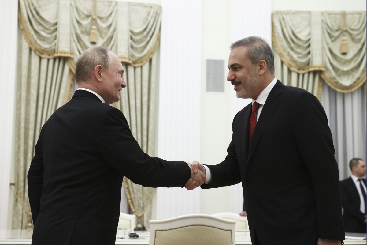 Russian President Vladimir Putin, left, and Turkey's Foreign Minister Hakan Fidan shake hands during their meeting at the Kremlin in Moscow, Russia, Tuesday, June 11, 2024. (Mikhail Metzel, Sputn ...