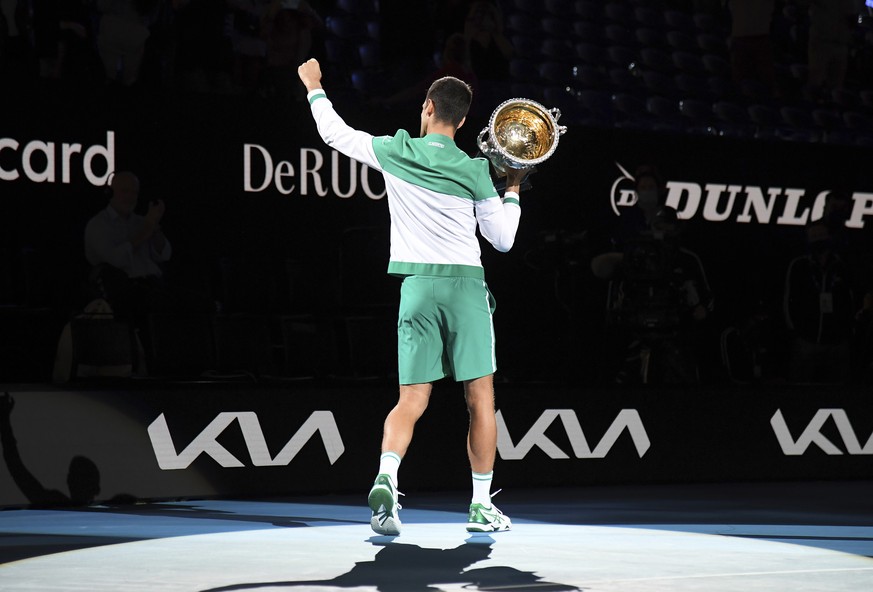 Serbia's Novak Djokovic holds the Norman Brookes Challenge Cup aloft after defeating Russia's Daniil Medvedev in the men's singles final at the Australian Open tennis championship in Melbourne, Austra ...