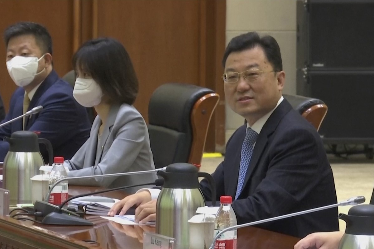 In this image taken from a July 26, 2021, video footage run by Phoenix TV via AP Video, China's Deputy Foreign Minister Xie Feng looks up before talks with visiting U.S. officials at the Tianjin  ...