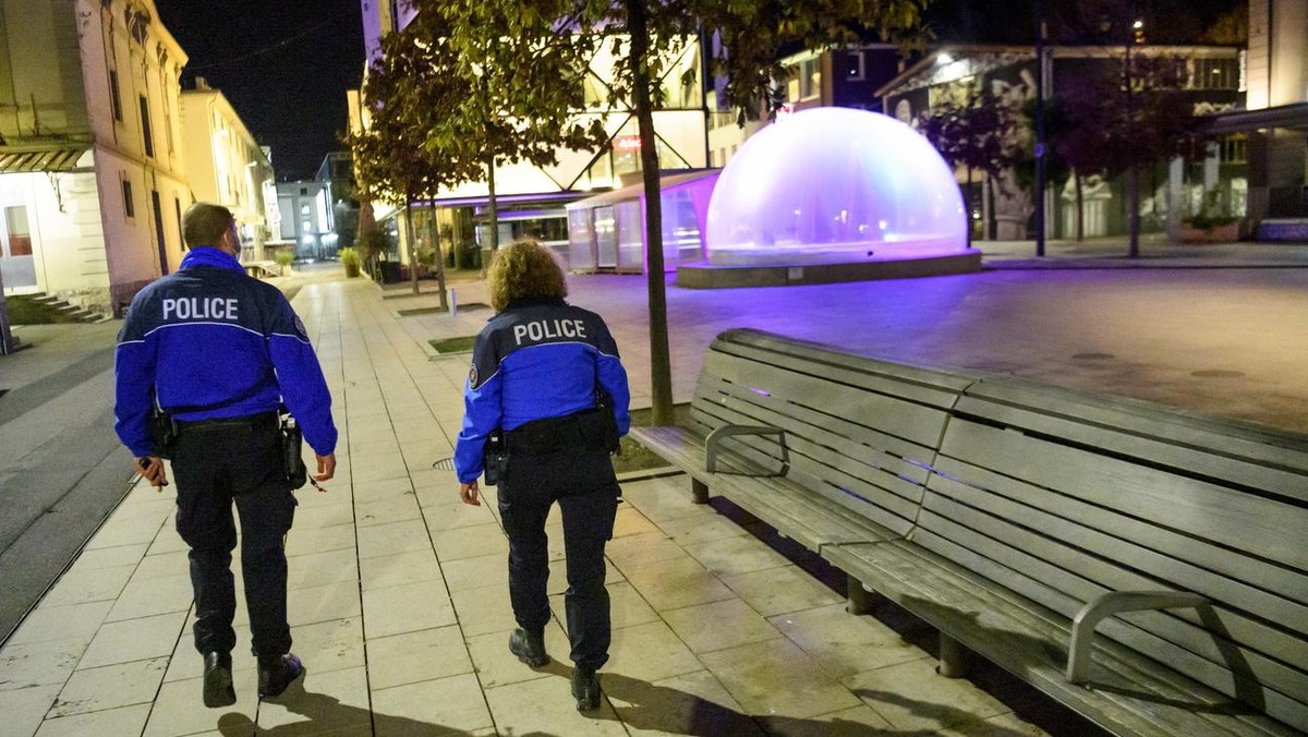 Lausanne's Police officers patrol to prevent the gathering of more than 5 people in the empty "Quartier du Flon" night district during the coronavirus disease (COVID-19) outbreak, late  ...