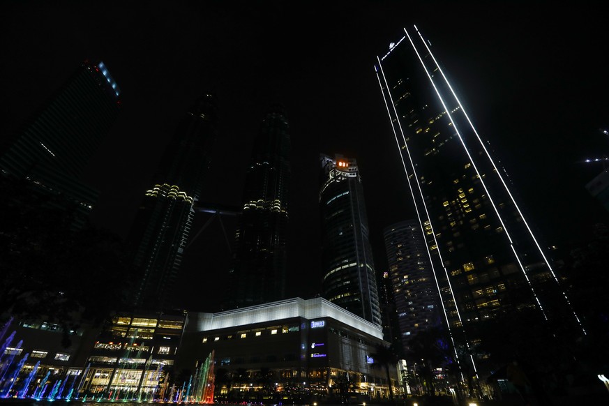 epa09101245 A night view of Malaysia&#039;s landmark Petronas Twin Towers as lights are switched off for an hour to mark the Earth Hour 2021 in Kuala Lumpur, Malaysia, 27 March 2021. Earth Hour is an  ...