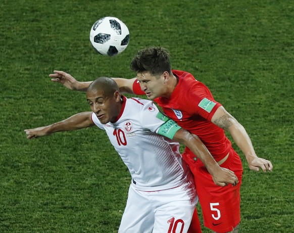 England&#039;s John Stones, right, and Tunisia&#039;s Wahbi Khazri challenge for the ball during the group G match between Tunisia and England at the 2018 soccer World Cup in the Volgograd Arena in Vo ...