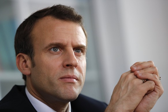 epa06646576 French President Emmanuel Macron listens to hospital staff (not pictured) as he visits the Rouen hospital, Normandy, France, 05 April 2018. Macron presented an autism plan to provide basic ...