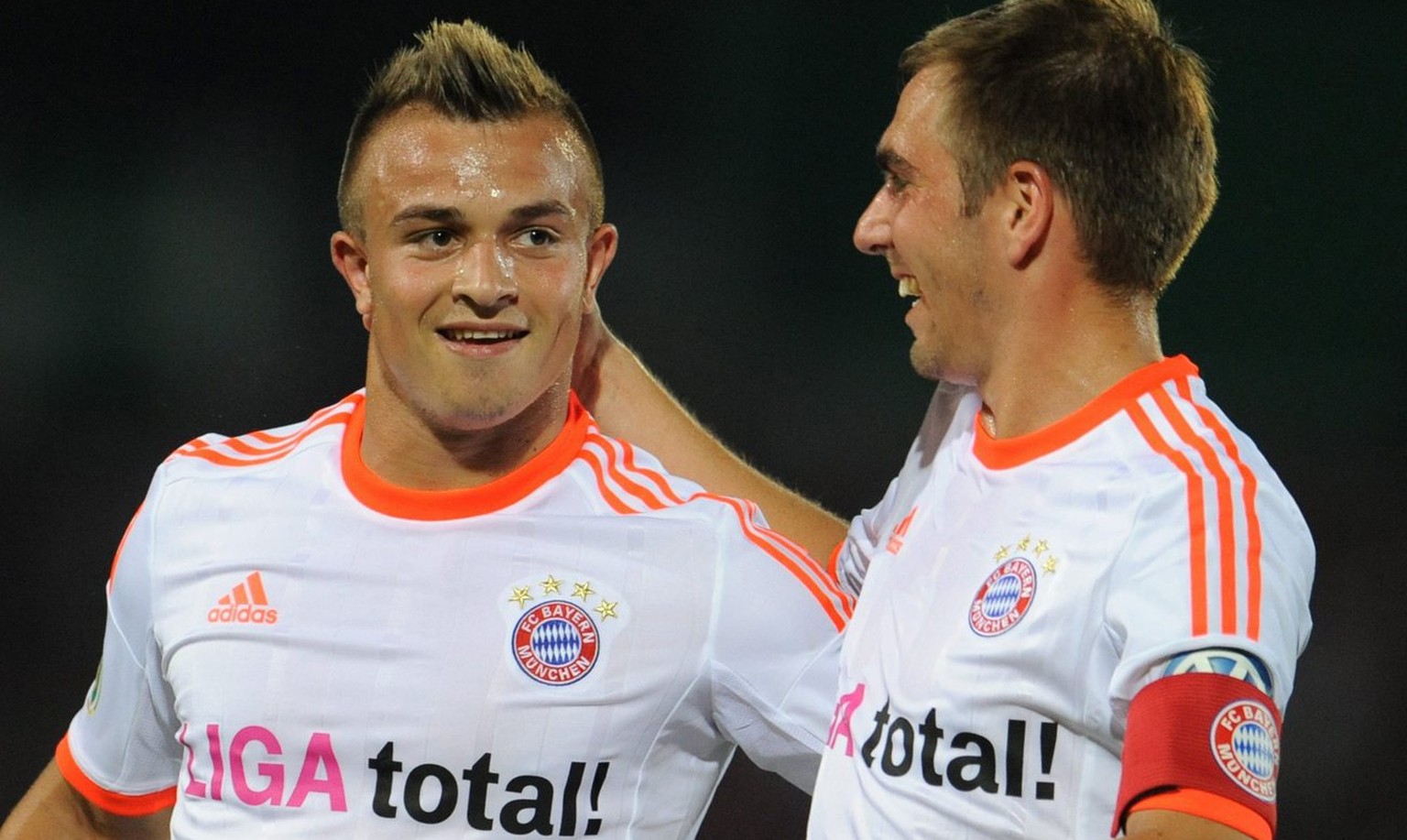 epa03366309 Munich&#039;s Xherdan Shaqiri (L) and Philipp Lahm celebrate the victory over Regensburg after the DFB Cup first round soccer match SSV Jahn Regensburg vs FC Bayern Munich at the Jahnstadi ...