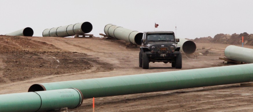 FILE PHOTO: A vehicle drives next to a series of pipes at a Dakota Access Construction site near the town of Cannon Ball, North Dakota, U.S. on October 30, 2016. REUTERS/Josh Morgan/File Photo TPX IMA ...