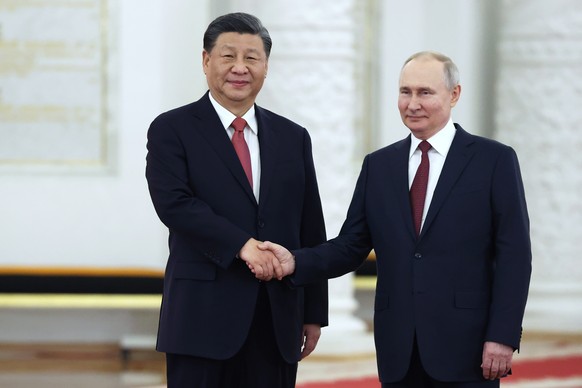 Russian President Vladimir Putin, right, and Chinese President Xi Jinping pose for a photo during an official welcome ceremony at The Grand Kremlin Palace, in Moscow, Russia, Tuesday, March 21, 2023.  ...