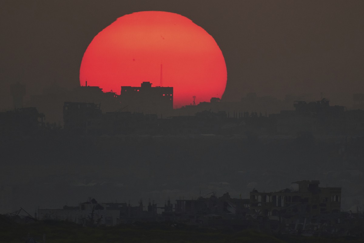 The sun sets behind the buildings that were destroyed during the Israeli air and ground offensive in the Gaza Strip as seen from southern Israel, Monday, March 10, 2025. (AP Photo/Leo Correa)
APTOPIX  ...