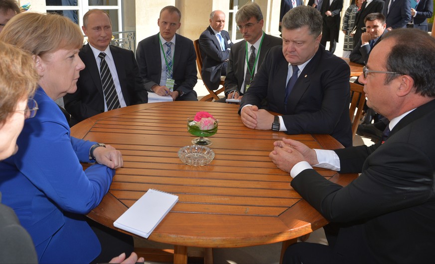 Sitting round a table for talks are from left, clockwise: German Chancellor Angela Merkel, Russian President Vladimir Putin, Ukrainian President Petro Poroshenko and French President Francois Hollande ...